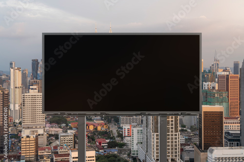Canvas Print Blank black road billboard with Kuala Lumpur cityscape background at sunset