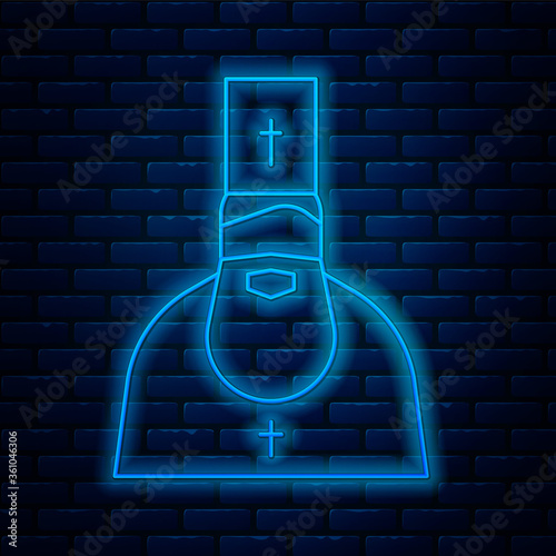Glowing neon line Priest icon isolated on brick wall background. Vector Illustration.