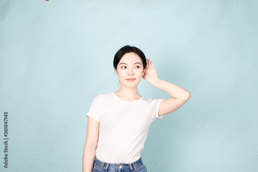 A young chinese woman in front of blue background A young chinese woman in front of blue background