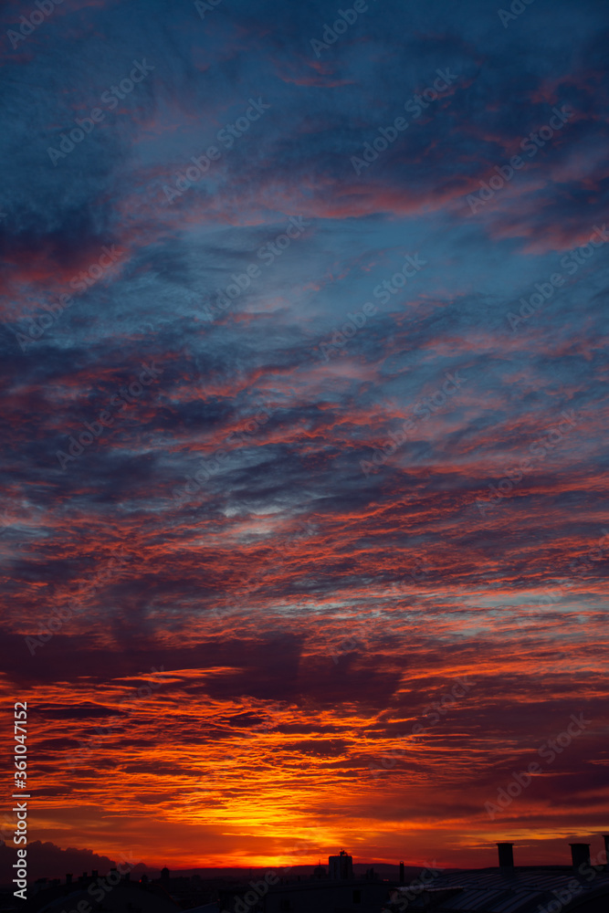 Dramatic cloudy blue, orange and red sunset