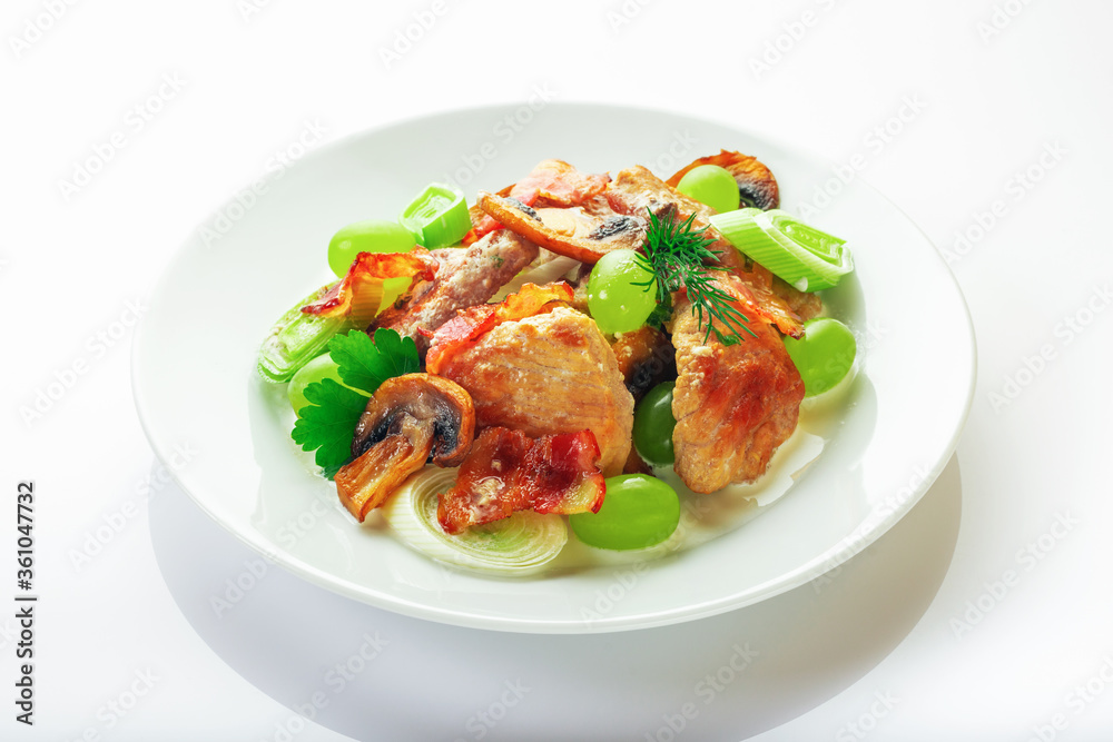 Pork with mushrooms, grapes, leek and parsley. High key. Selective focus. Pork with mushrooms, grapes, leek and parsley. High key. Selective focus.