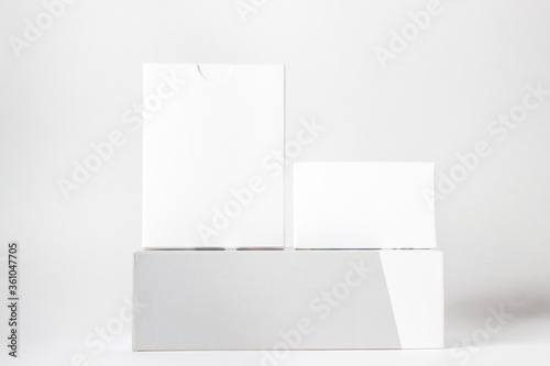 Three white boxes on a white background. On the boxes there is a place for inscriptions and logos