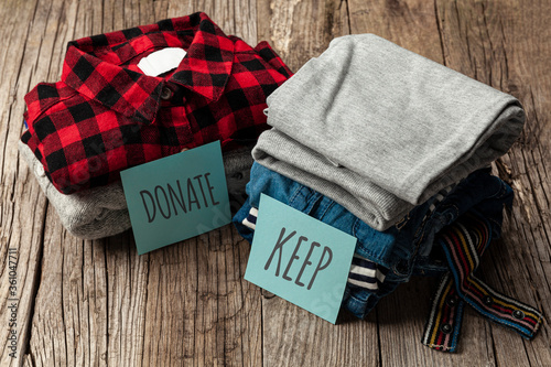 Cuadro en lienzo Stack of old clothes to discard (declutter) or keep