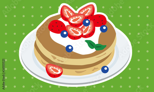 お皿に乗ったブルーベリーといちごのパンケーキ