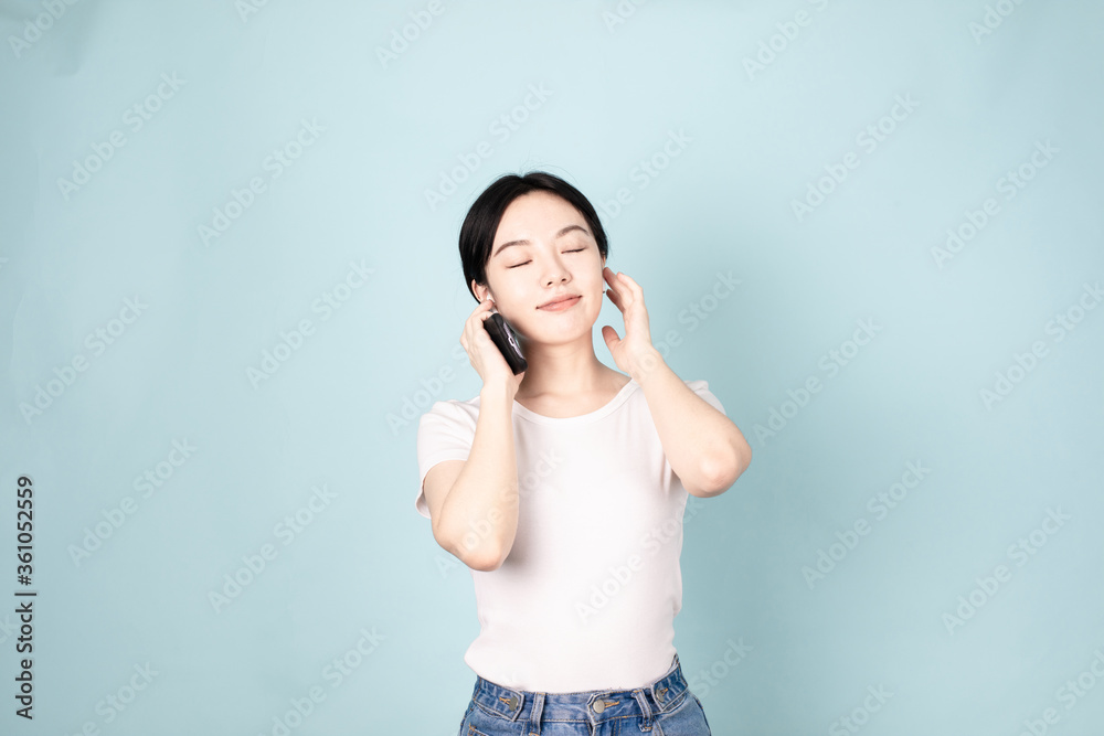 A Young Chinese Woman In Front of Blue Background A Young Chinese Woman In Front of Blue Background