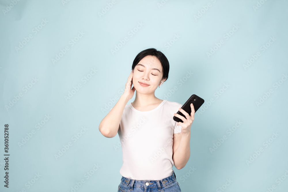 A Young Chinese Woman In Front of Blue Background A Young Chinese Woman In Front of Blue Background