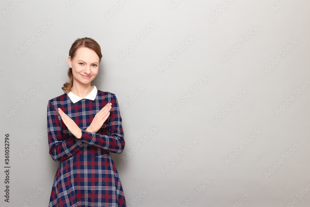 Portrait of happy girl making cross with hands and smiling joyfully Portrait of happy girl making cross with hands and smiling joyfully
