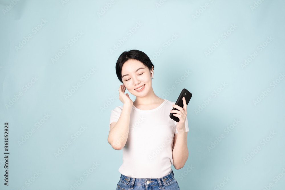 A Young Chinese Woman In Front of Blue Background A Young Chinese Woman In Front of Blue Background