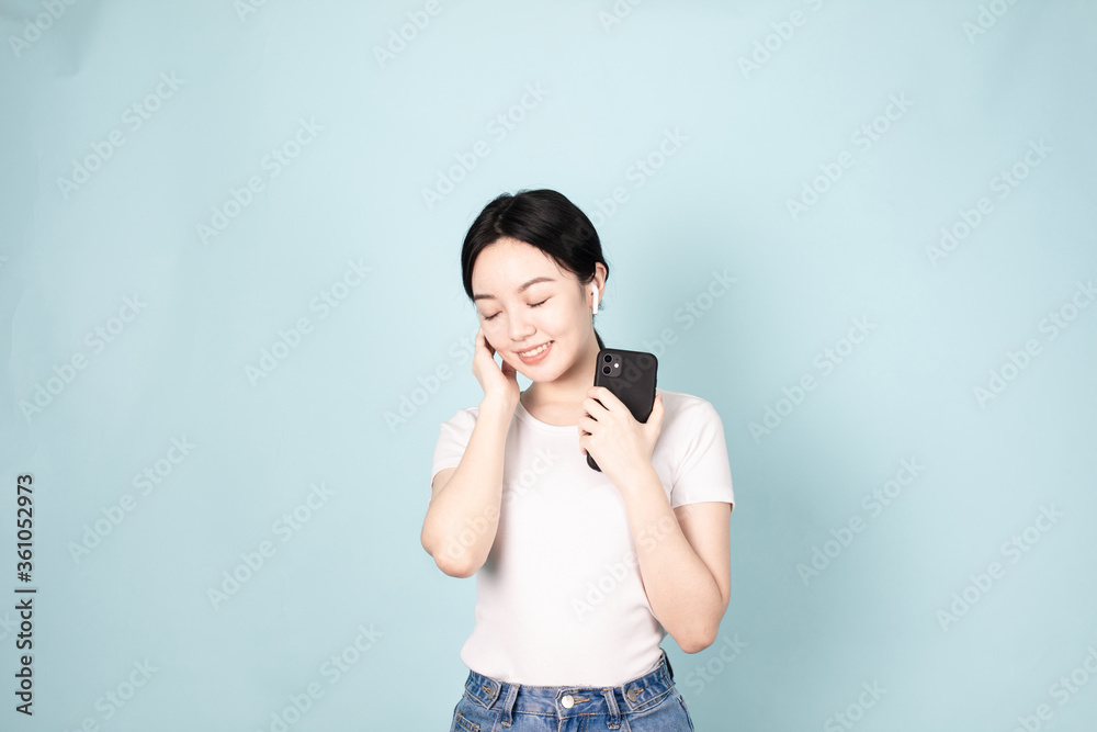 A Young Chinese Woman In Front of Blue Background A Young Chinese Woman In Front of Blue Background
