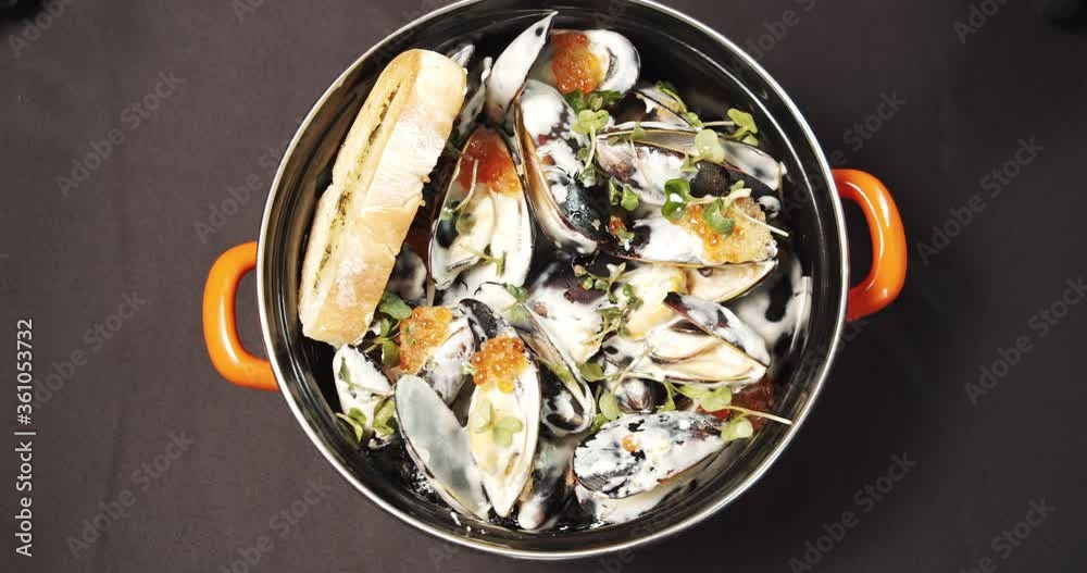Close-up of tasty mussels in a creamy sauce in a plate. Close-up of tasty mussels in a creamy sauce in a plate.