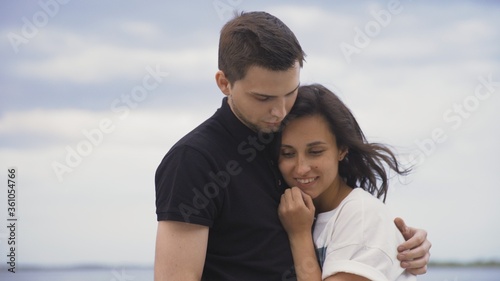 Attractive romantic couple embrace outdoors. Young couple spending time together