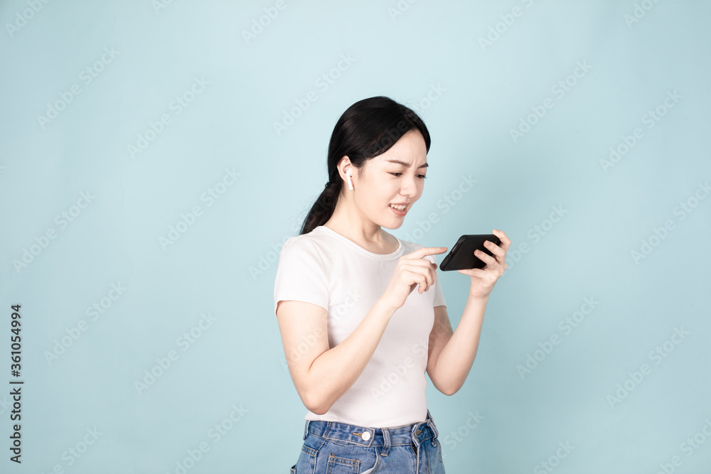 A Young Chinese Woman In Front of Blue Background