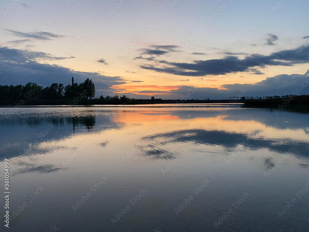 Sunset reflection on lake, summer vibes.