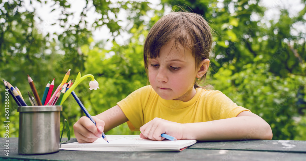 Humorous photo of great artist. Portrait of cute little child girl with colored pencils. Horizontal image. Humorous photo of great artist. Portrait of cute little child girl with colored pencils. Horizontal image.