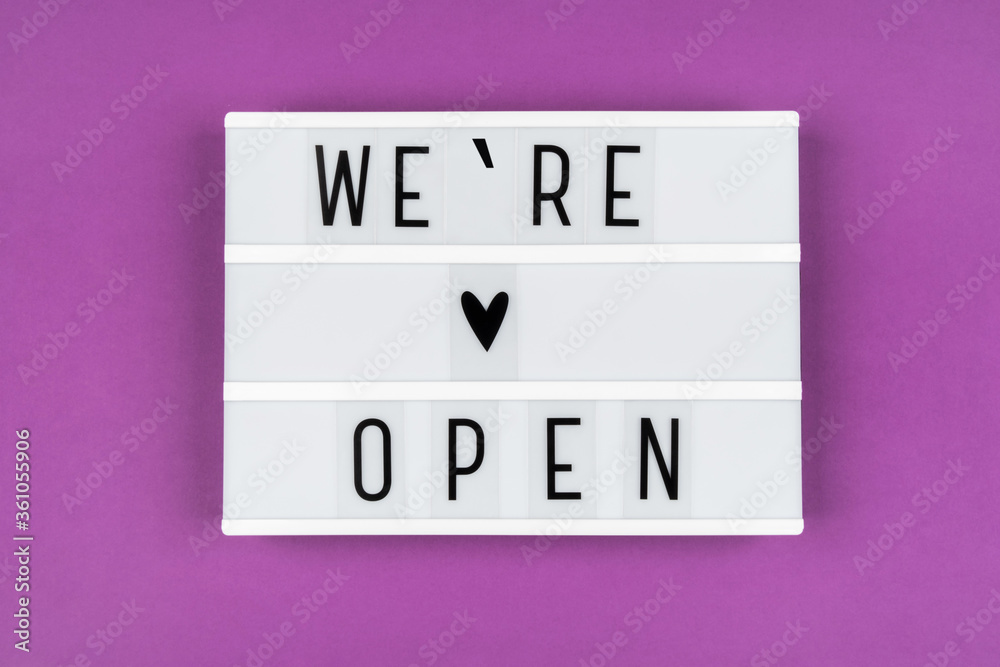 Text WE OPENED on a lightbox on a purple background. Information message for clients from the business owner Text WE OPENED on a lightbox on a purple background. Information message for clients from the business owner