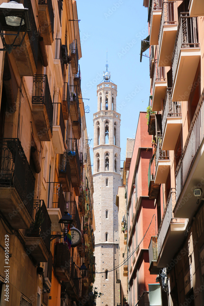 View of the tower of the cathedral Santa Maria del Mar and the balconies of the houses in the Gothic Quarter of Barcelona