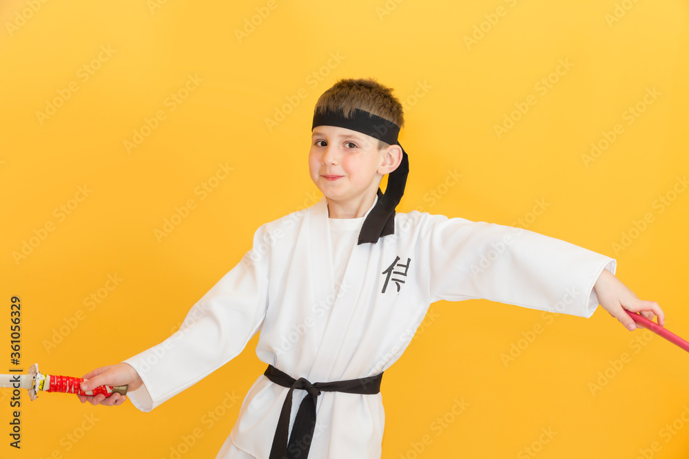 Little boy as a karate fighter. Funny faces.