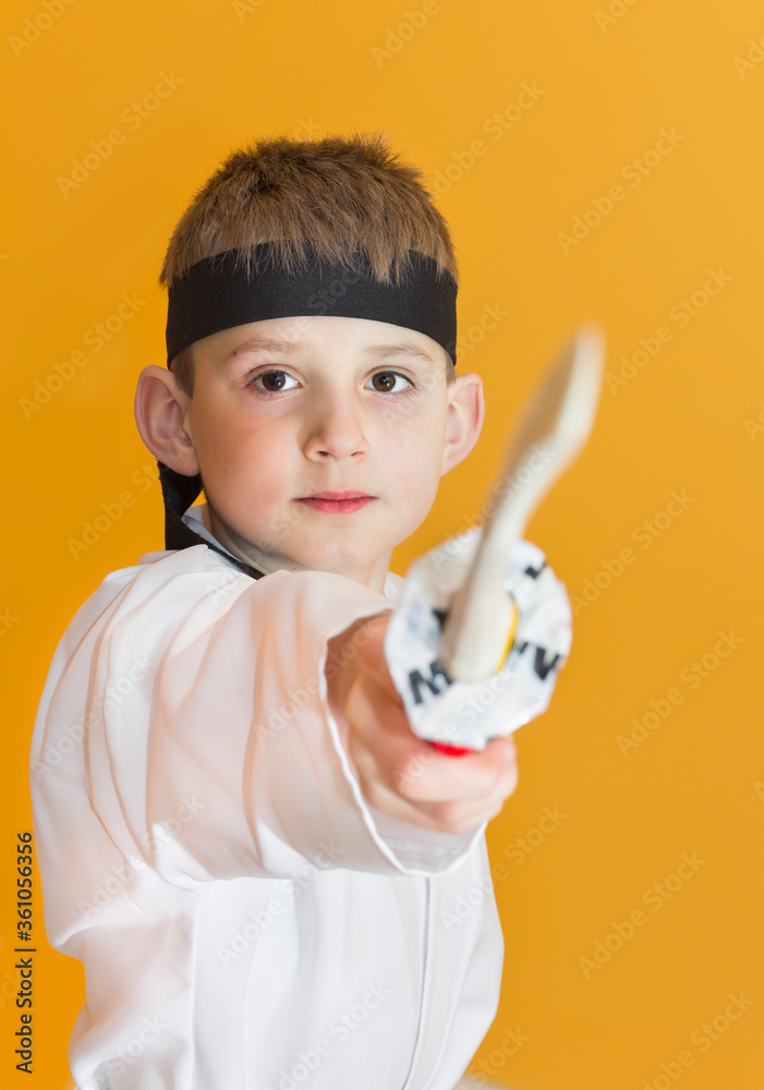 Little boy as a karate fighter. Funny faces.