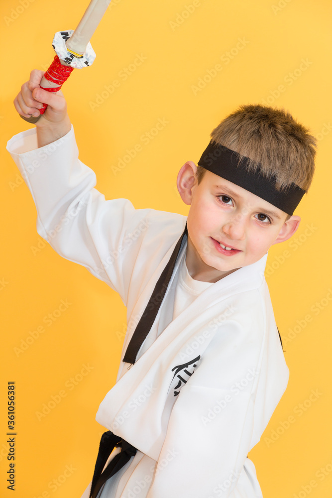 Little boy as a karate fighter. Funny faces.