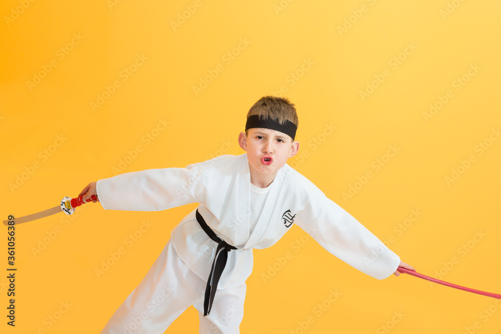 Little boy as a karate fighter. Funny faces.