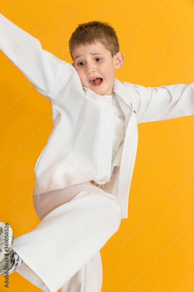 Little boy as a karate fighter. Funny faces.