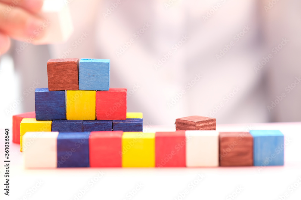 Businessman hand arranging wood cube stacking as step stair. Business concept growth success process and plan growth and increase of positive indicators in his business Businessman hand arranging wood cube stacking as step stair. Business concept growth success process and plan growth and increase of positive indicators in his business