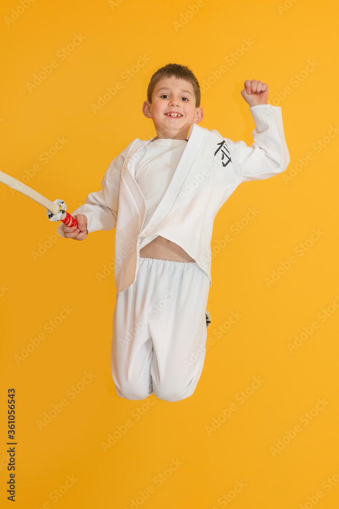 Little boy as a karate fighter. Funny faces.