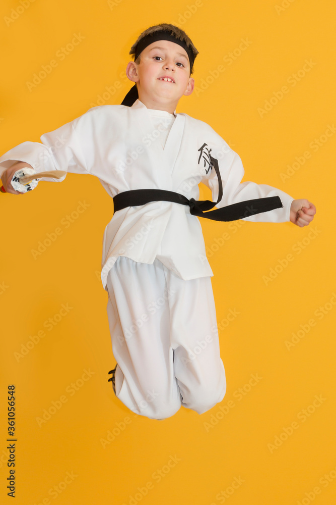 Little boy as a karate fighter. Funny faces.
