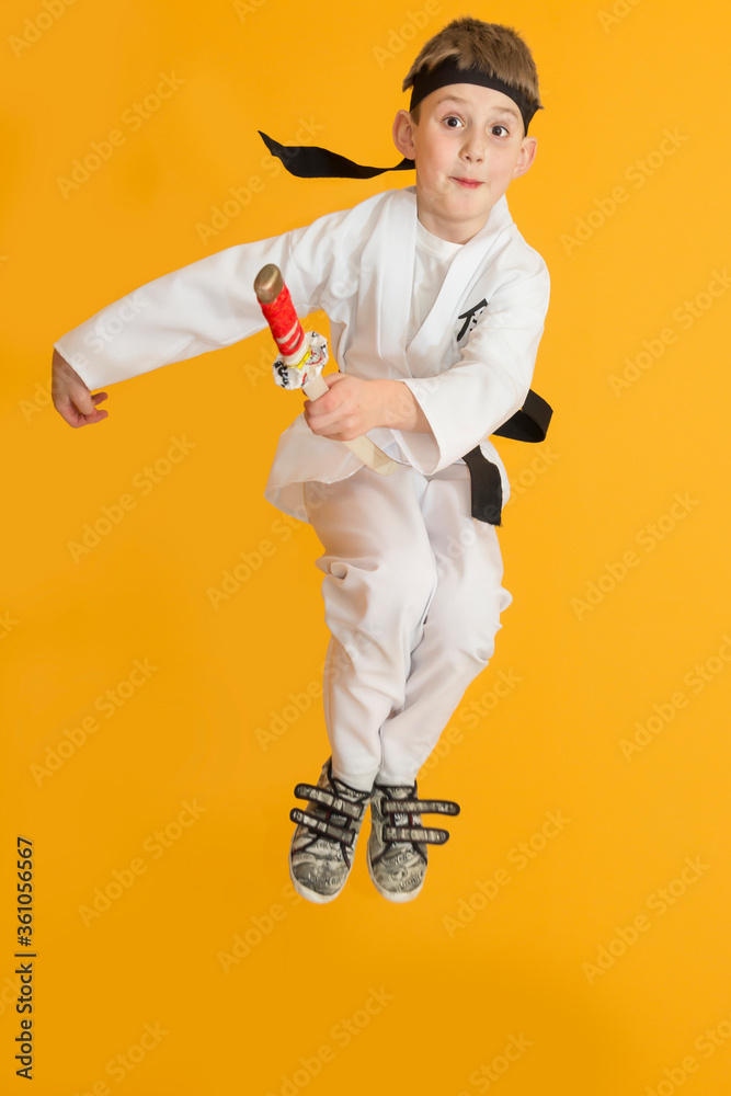 Little boy as a karate fighter. Funny faces.