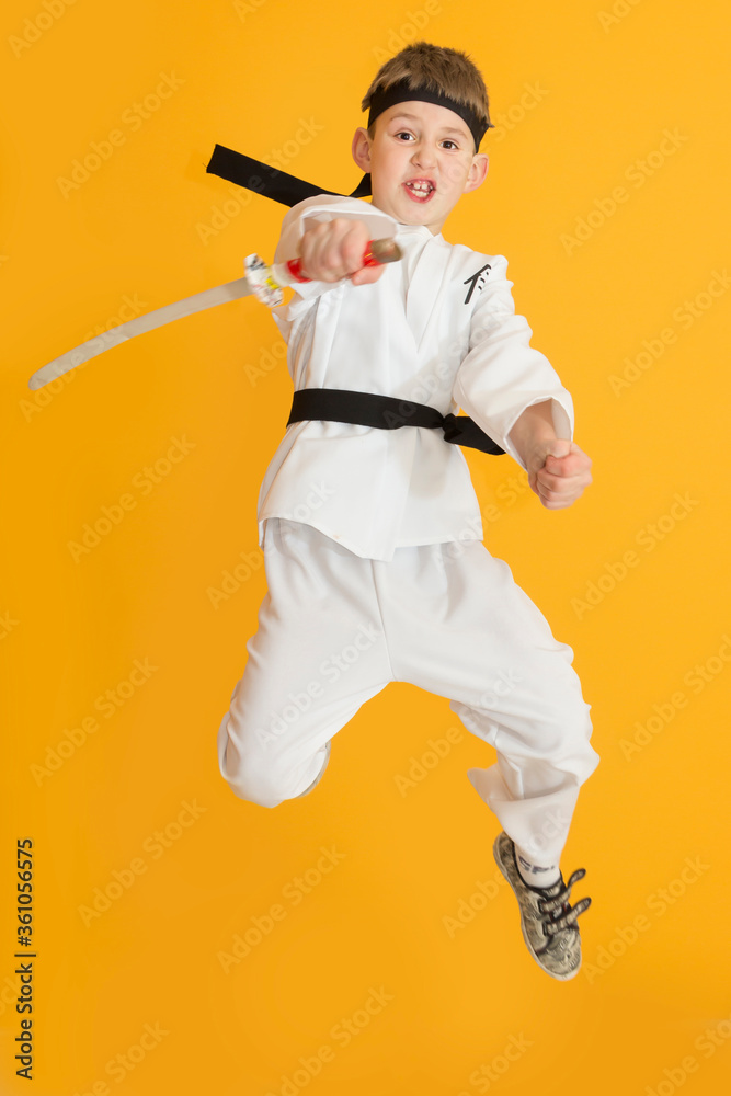 Little boy as a karate fighter. Funny faces.