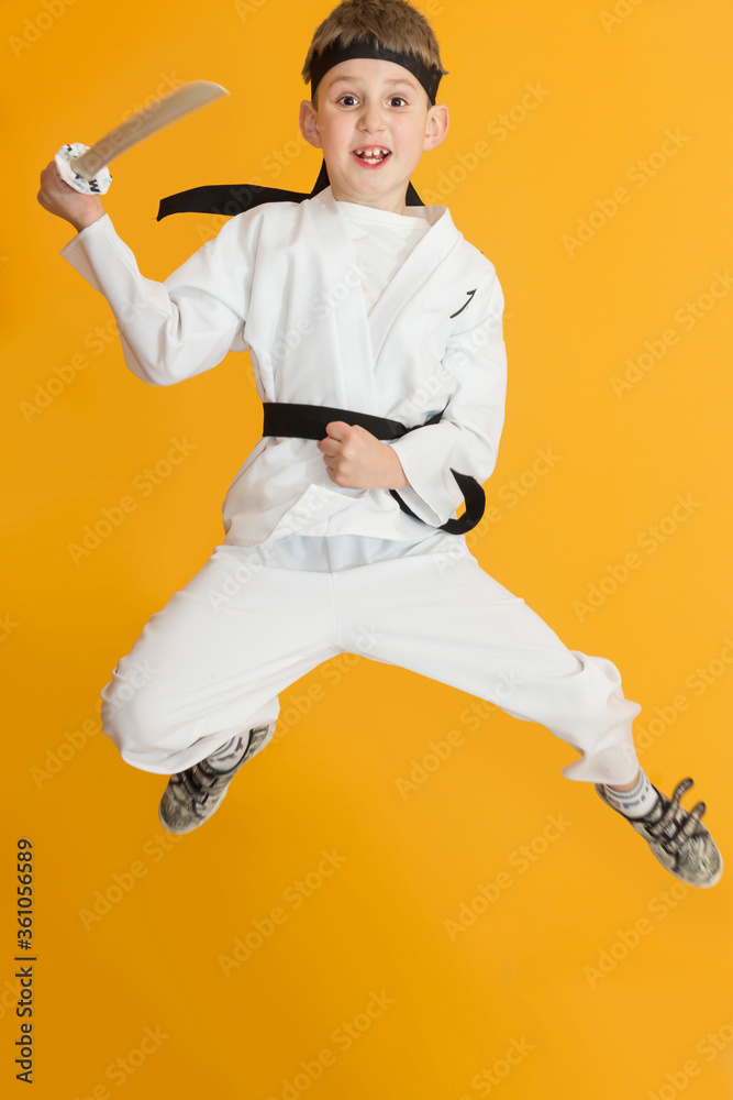 Little boy as a karate fighter. Funny faces.