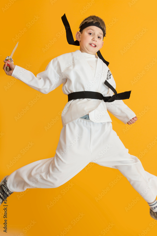 Little boy as a karate fighter. Funny faces.