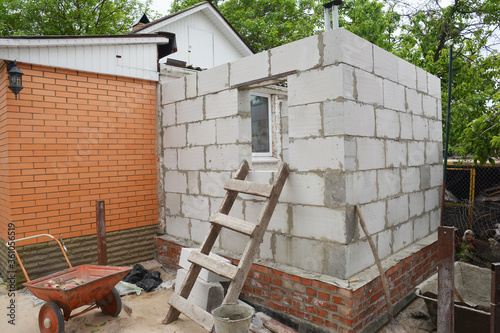 Building home addition from aerated autoclaved concrete blocks to a brick house.