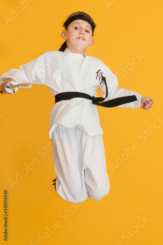 Obraz na płótnie Little boy as a karate fighter. Funny faces. w salonie