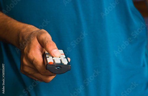 male hand holding a remote