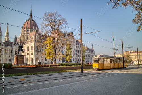 Square before Hungarian paliament building with moving tram in Budapest. photo