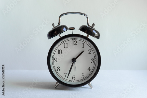 clock with an alarm clock on a white background. time management, business investment, planning