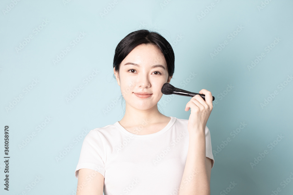A Young Chinese Woman In Front of Blue Background A Young Chinese Woman In Front of Blue Background