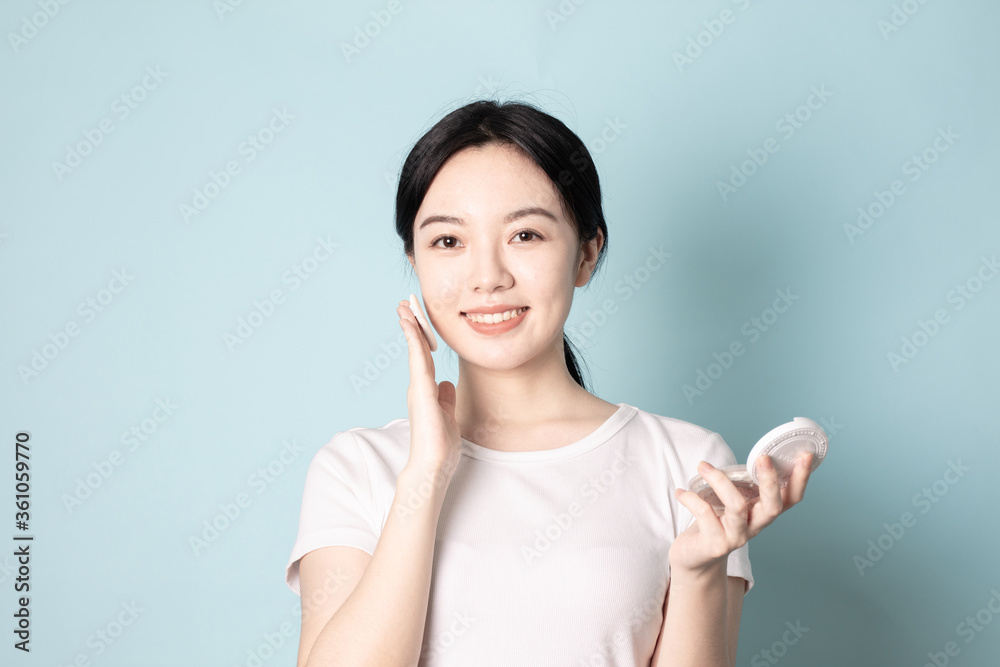 A Young Chinese Woman In Front of Blue Background A Young Chinese Woman In Front of Blue Background