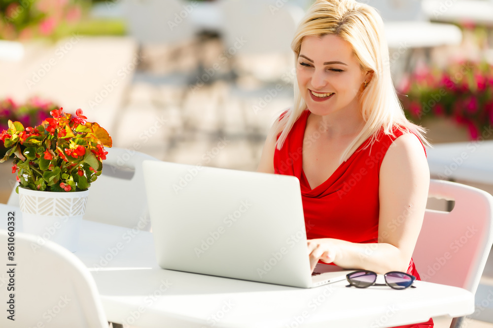 Young pretty woman with laptop on the bench in a park Young pretty woman with laptop on the bench in a park