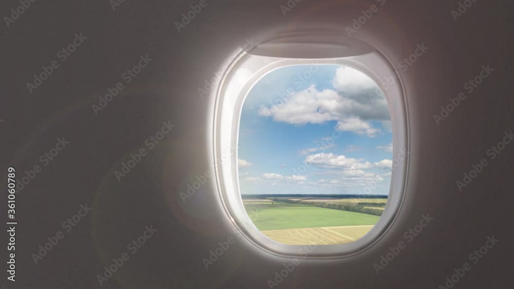Aerial video above agricultural lands on a background of cloudy sky from window inside aircraft. Aerial video above agricultural lands on a background of cloudy sky from window inside aircraft.