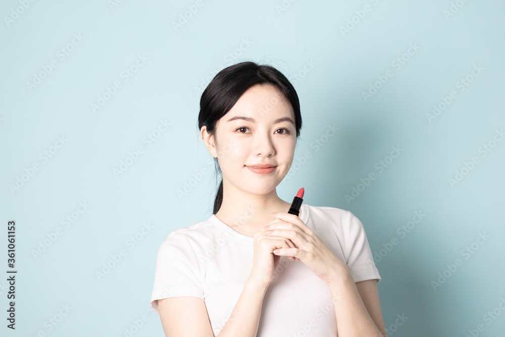 A Young Chinese woman in front of a blue background