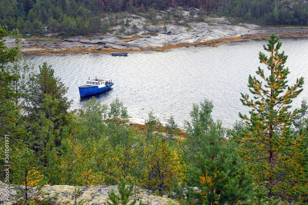 Karelian landscape. Motor boat by Sidorov island. Kandalaksha Gulf of White Sea. Republic of Karelia, Russia. Karelian landscape. Motor boat by Sidorov island. Kandalaksha Gulf of White Sea. Republic of Karelia, Russia.