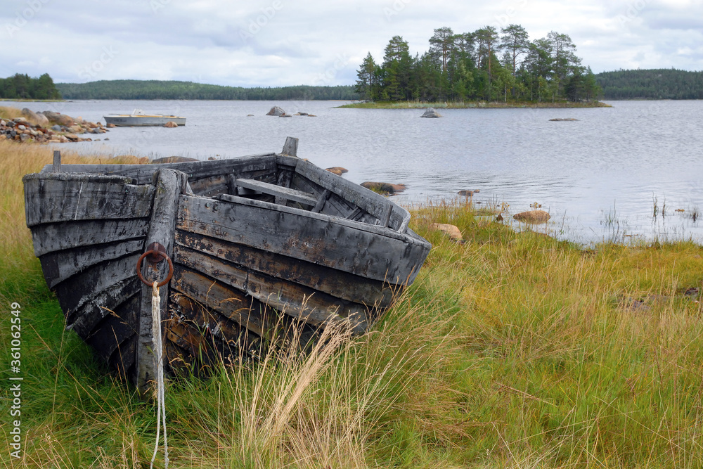 Traditional wooden boat on the shore of Chupa bay of White Sea. Republic of Karelia, Russia.