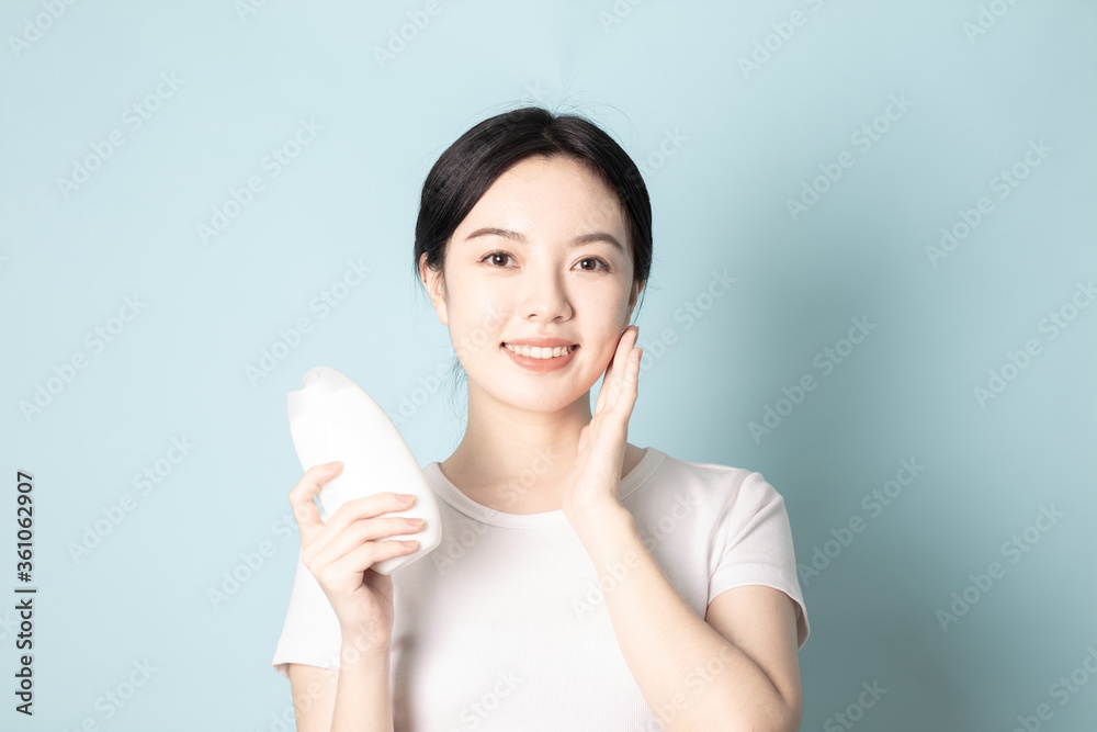A Young Chinese woman in front of a blue background A Young Chinese woman in front of a blue background