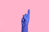 Isolated female light hand in a medical glove, touching or pointing at something
