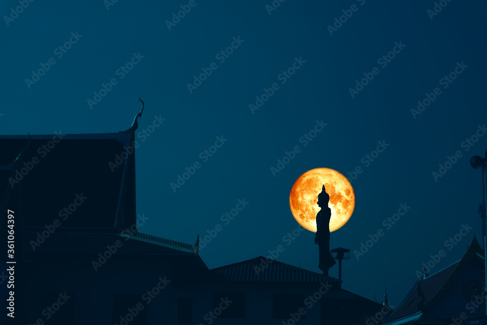Sunday Buddha and blood moon on night sky in the Asanha bucha day