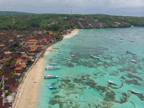 Coast Jungut Batu village with boats and hotels on the island of Lembongan. Indonesia. Aerial view. photo