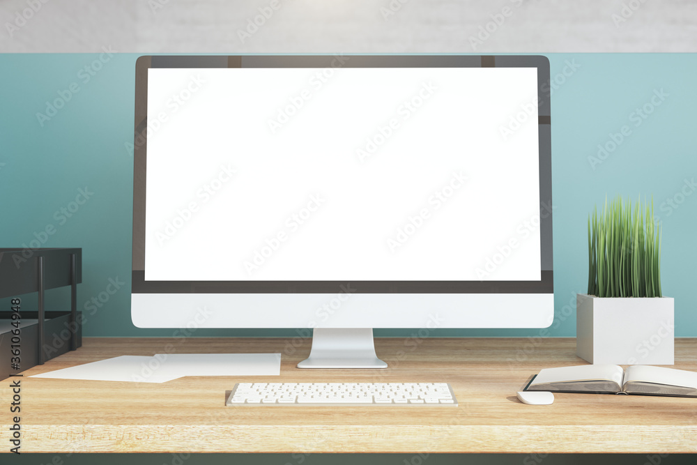 Side view designer desktop with empty white computer screen Side view designer desktop with empty white computer screen