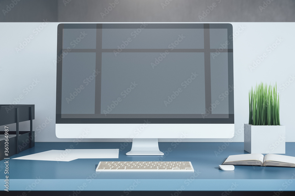 Fototapeta premium Side view office desk and computer with blank black screen.